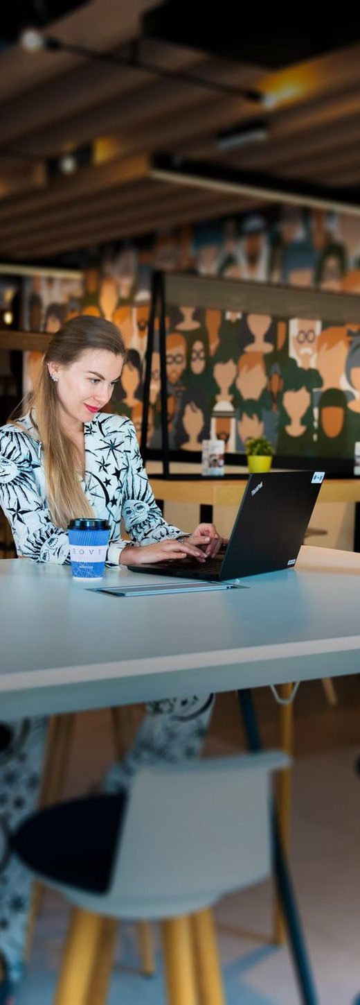 Woman working on laptop in co-working space
