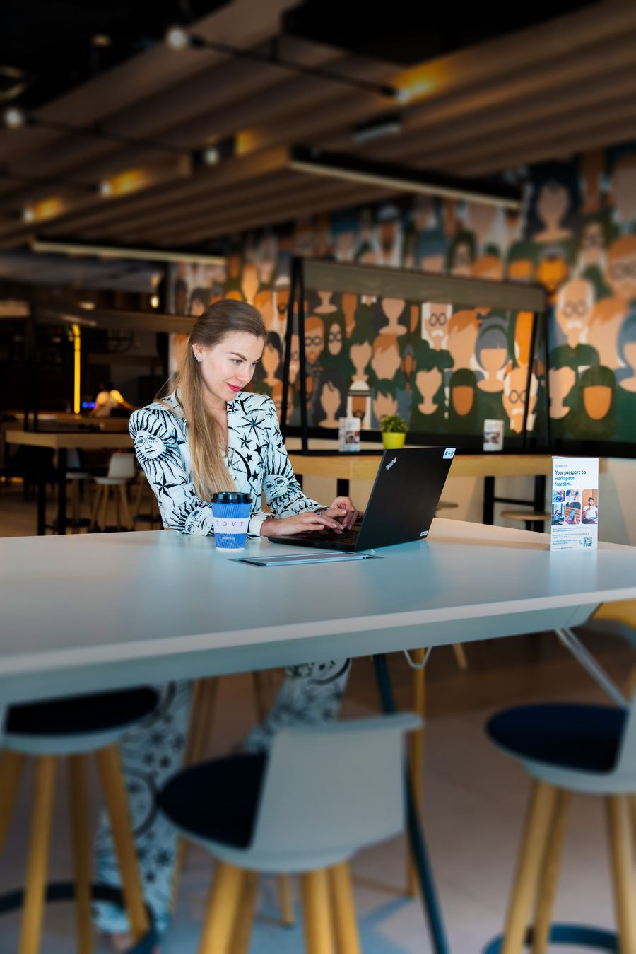 Woman working on laptop in co-working space
